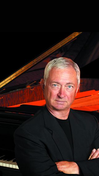 Lenny LaCroix seated at a grand piano